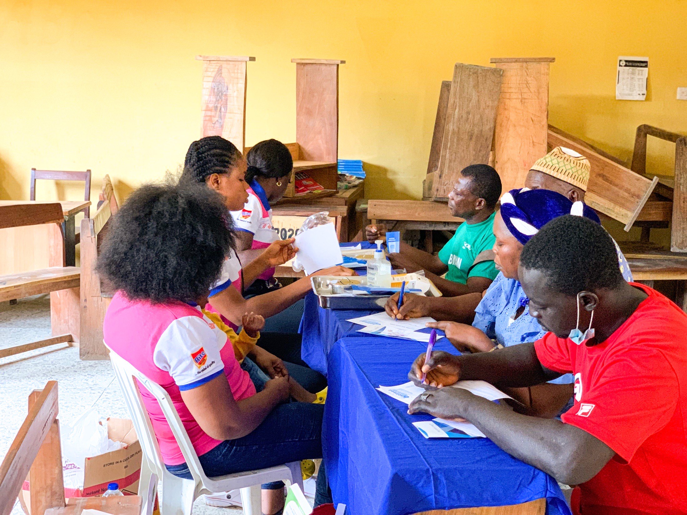 Community health outreach session with volunteers and participants.